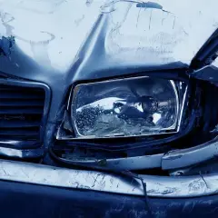 Uszkodzony przód samochodu po wypadku. Zgnieciona maska, zbita lampa. Warto mieć ochronę zniżek AC.
