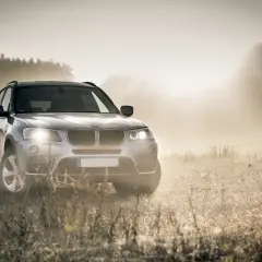 Srebrny SUV w mglistym krajobrazie, gotowy na każdą drogę. Idealny wariant serwisowy PZU dla Twojej podróży.